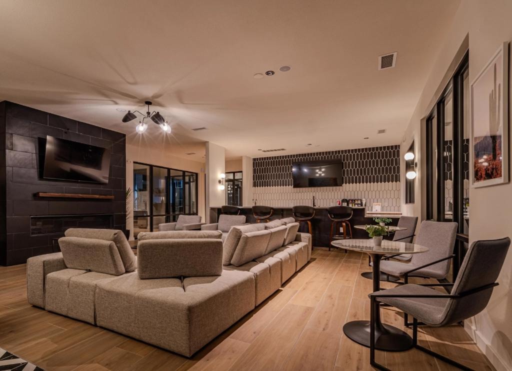 Desert Commons East — Resident lounge with fireplace and bar